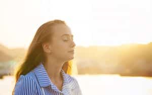 girl standing in a calm manner, eyes closed