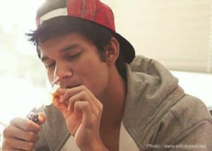 Young male smoking some sort of unidentifiable drug