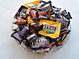 a bowl of various chocolate wraps