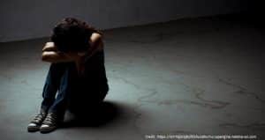 Young girl sitting on the floor crying