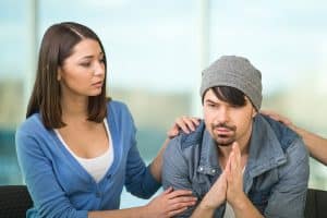 a woman is supporting her loved one who is in recovery.