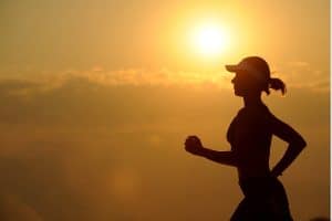 a woman practises jogging and exercising to cope with grief resulted from losses.