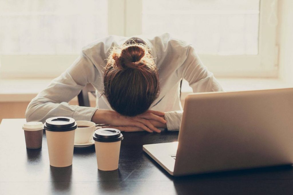 Business woman experiences the manic depression that causes her extreme exhaustion.