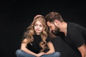 A father is trying to get his child’s attention