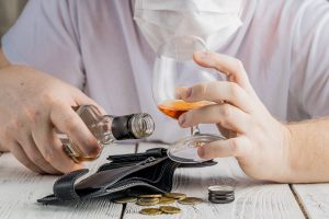 A man is struggling with alcohol dependence while living in isolation during COVID crisis.