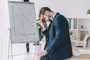 business man is facing stressful situations due to the impacts of COVID-19 on economic recession and job loss