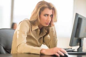 an office woman is feeling irritated with her unnecessary workload.
