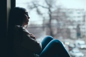 lonely woman is facing seasonal affective disorder during winter season.