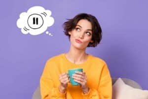 woman thinking of pressing pause button - Pressing Pause How to Stop Overthinking