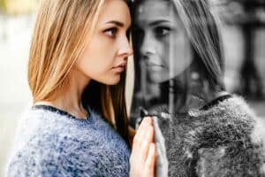 shadow work concept, Self reflection portrait of amazing young girl in mirrored window